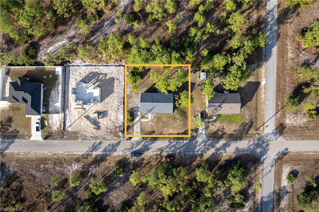 Aerial view of residential area with property parcel outlined
