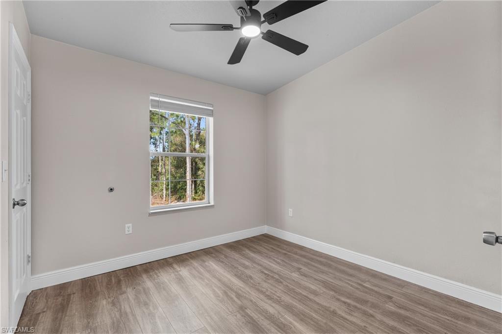 Spare room featuring light wood finished floors and a ceiling fan