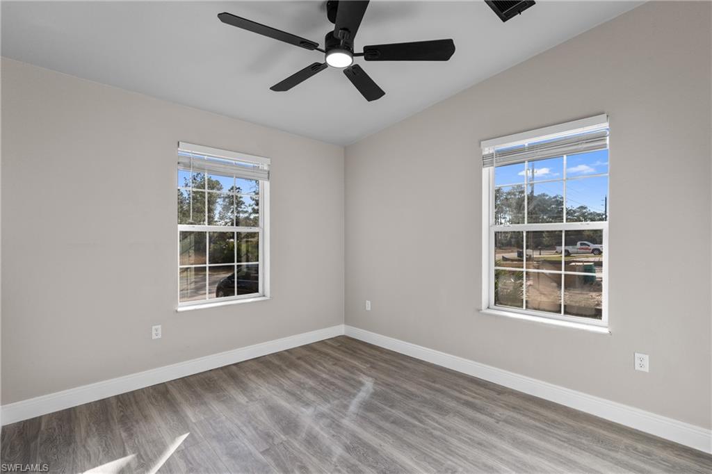 Spare room featuring wood finished floors and ceiling fan