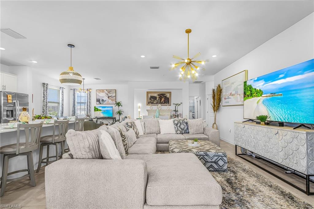 Open-concept living space featuring light wood-finish flooring and recessed lighting