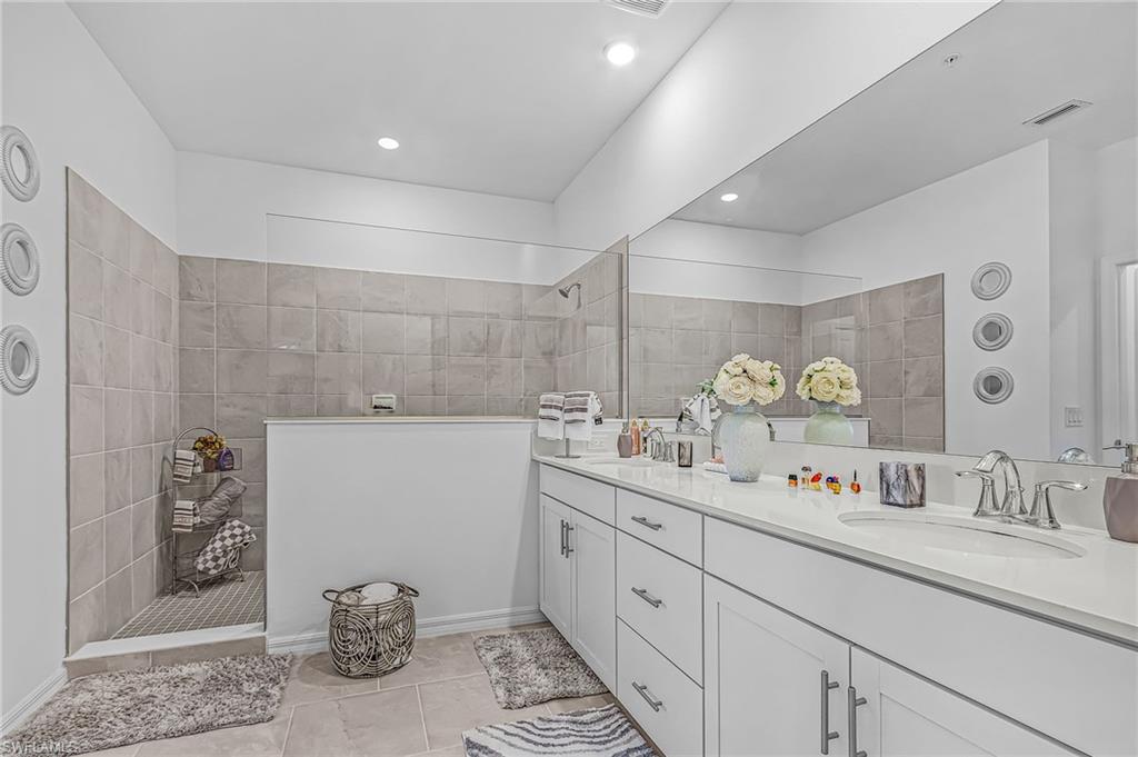 Dual vanity with white cabinetry and integrated sinks