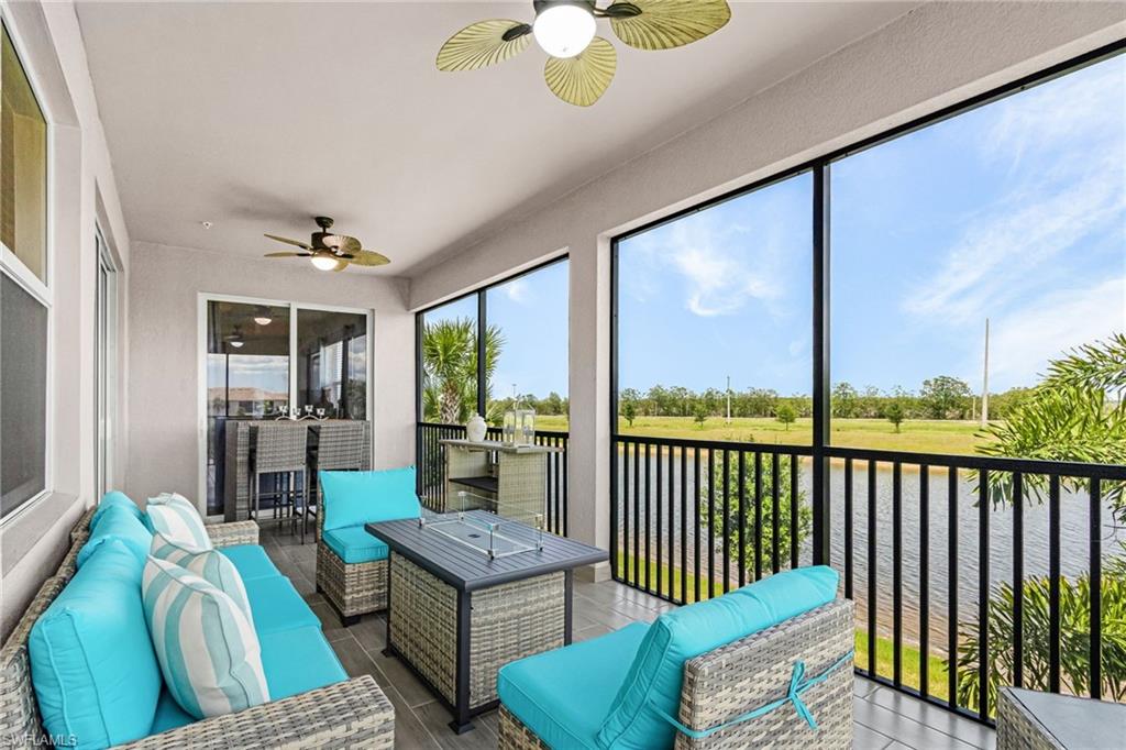 Screened patio featuring a ceiling fan, tiled flooring, and sliding glass doors