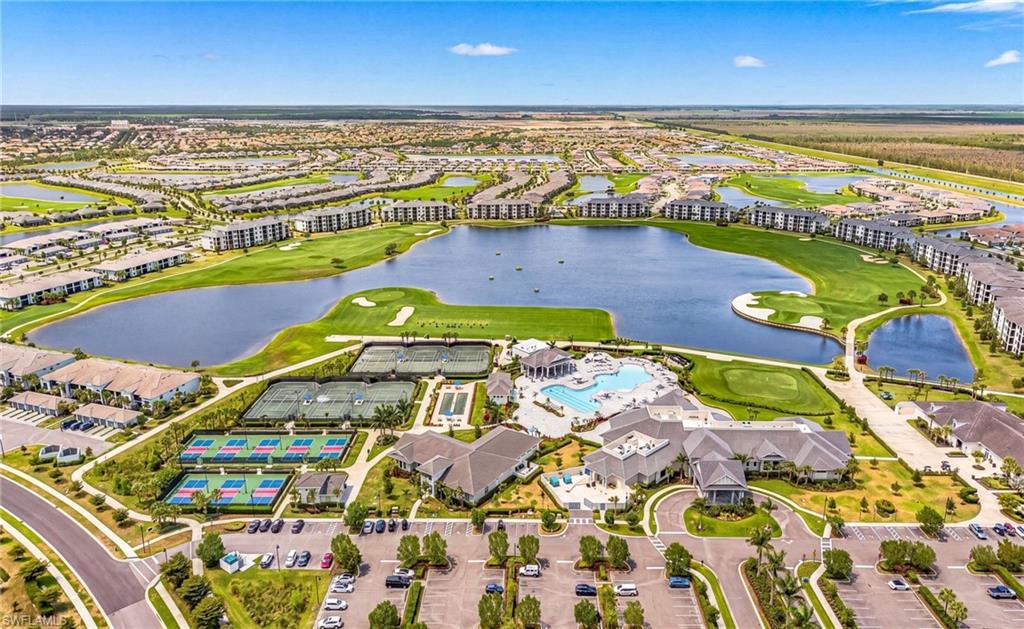 Expansive community featuring a central lake, golf course, multiple tennis courts, and pickleball courts