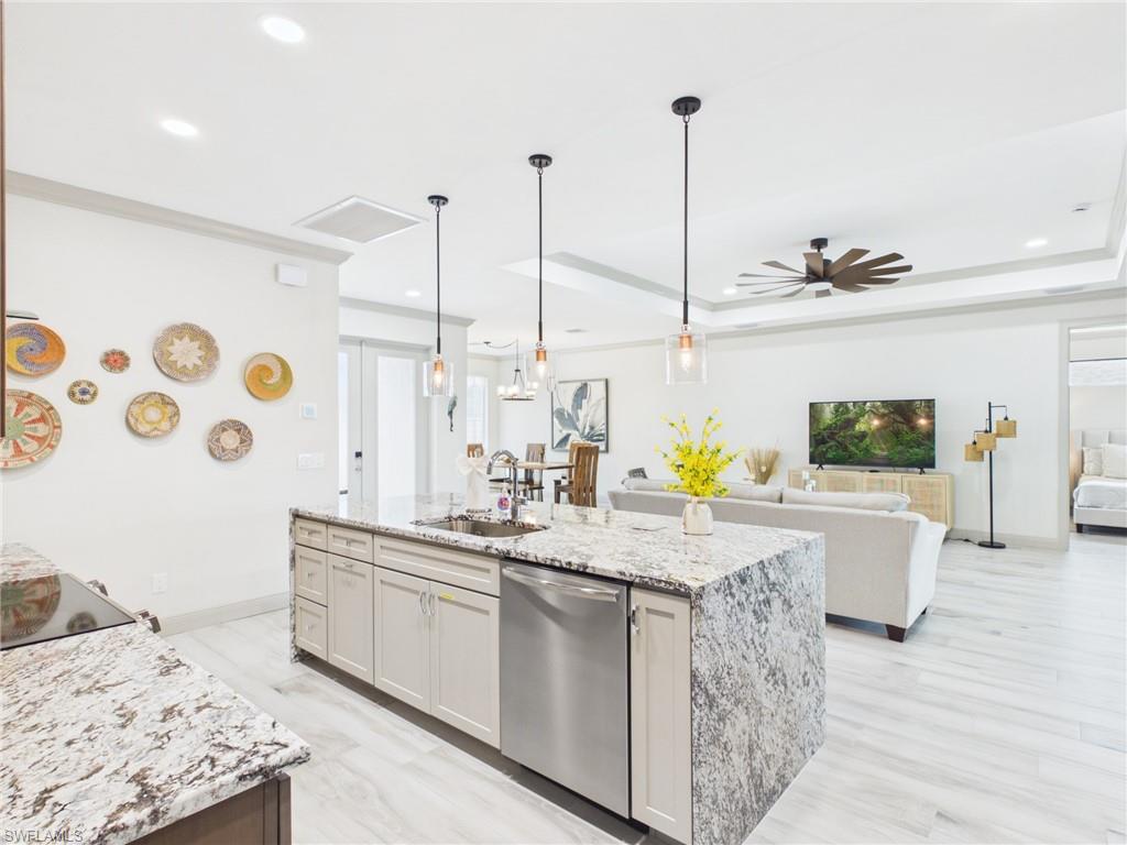 14x7 Laundry room featuring contemporary appliances, light wood-finish flooring, white walls, recessed lighting, and a built-in countertop with cabinetry