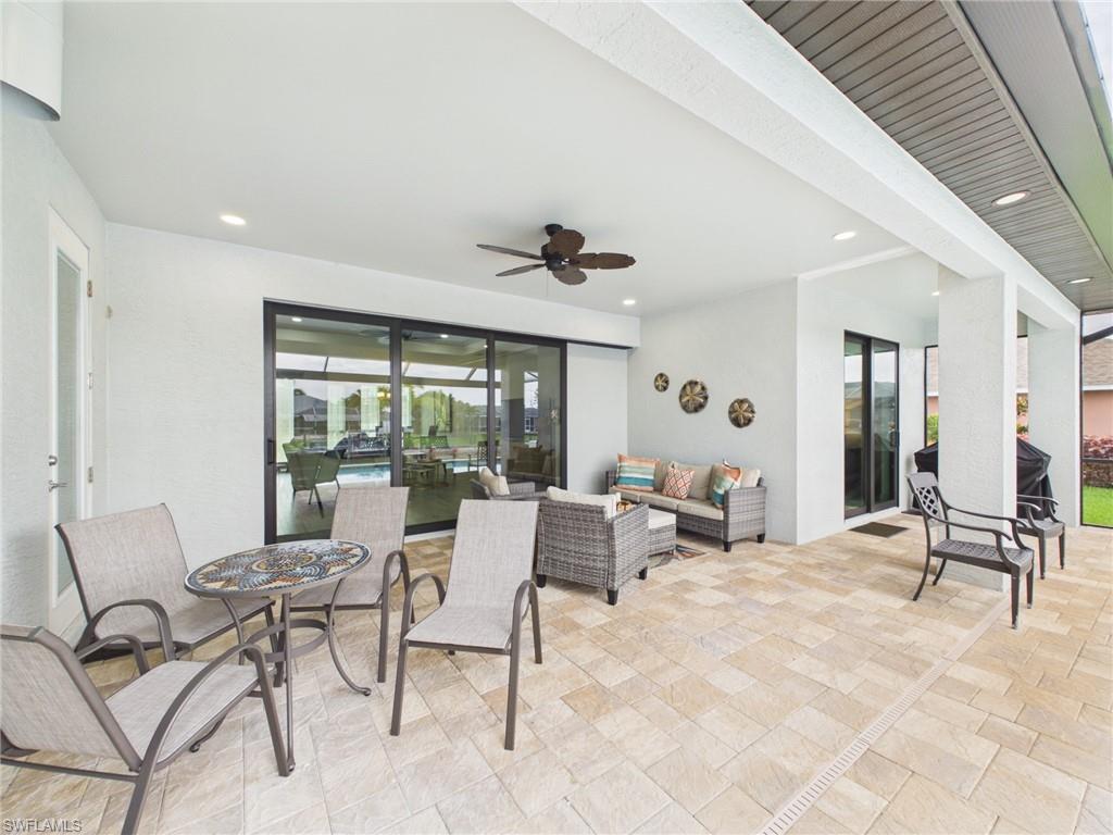 Expansive screened lanai featuring an in-ground pool, spa, and paver patio