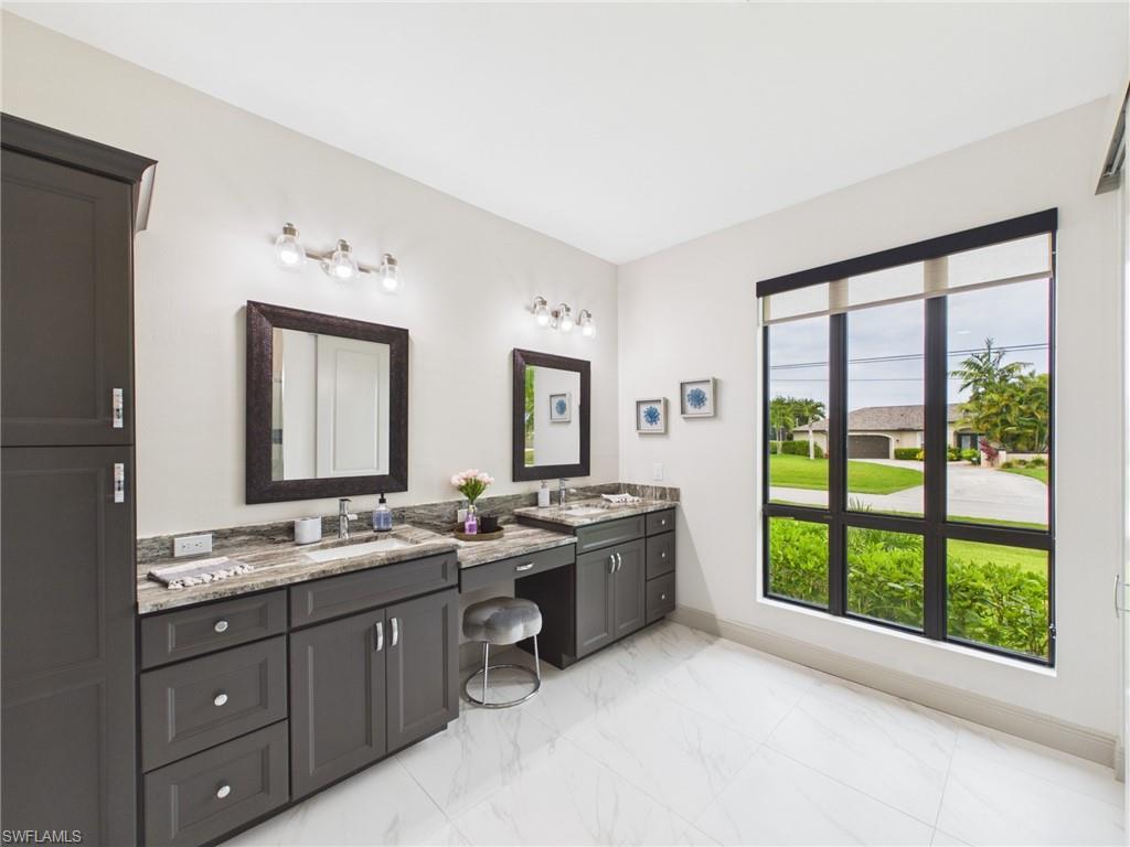 Spacious room featuring light-toned walls, wood-finish flooring, and a modern ceiling fan