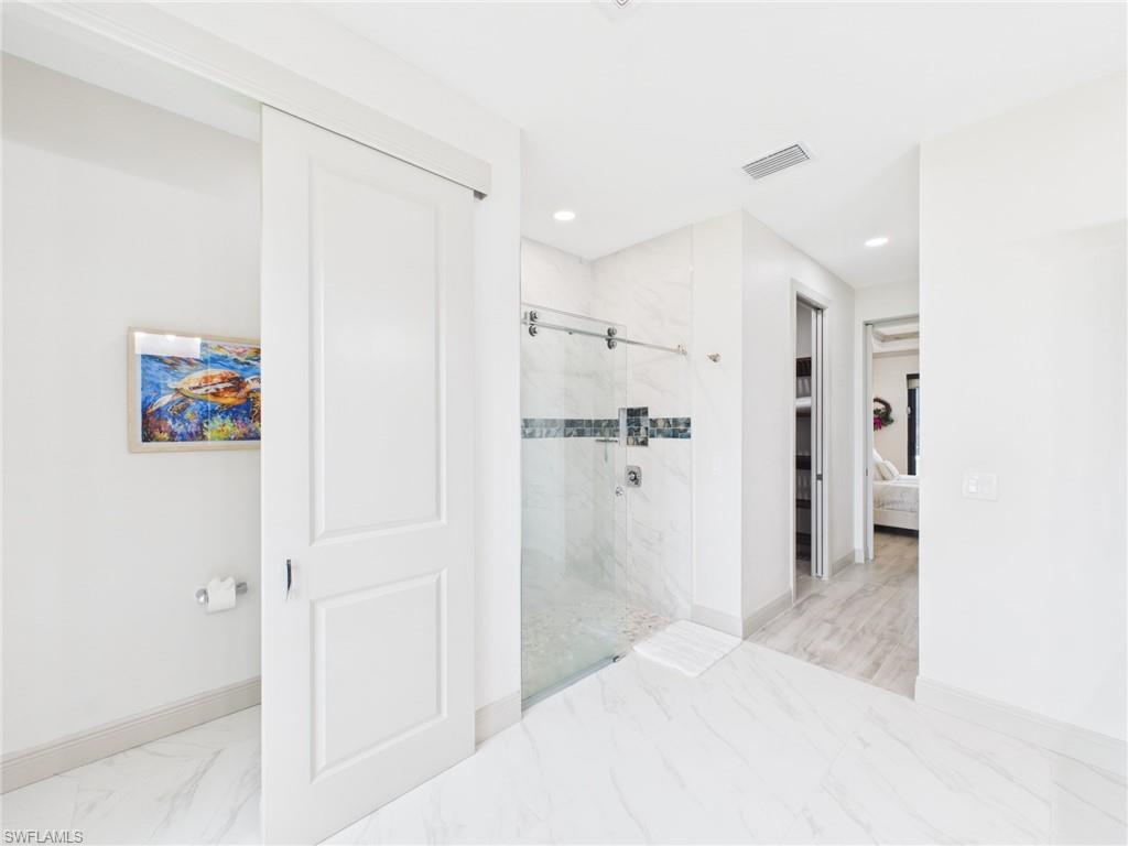 Light-toned wood-finish flooring complements the neutral wall color in this room