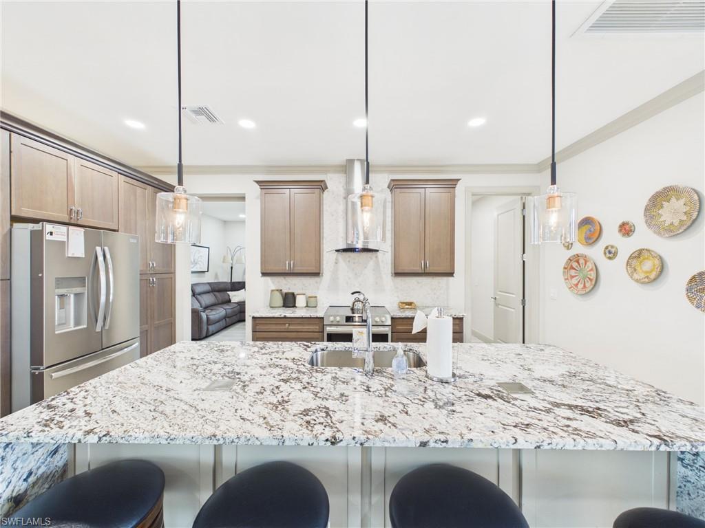 14x7 Dedicated laundry area featuring light wood-finish flooring, recessed lighting, and a built-in cabinet with a granite countertop