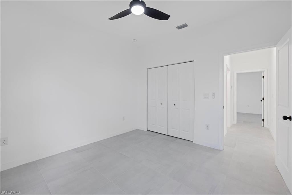 Unfurnished bedroom featuring a closet and ceiling fan