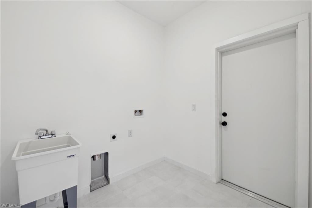 Laundry area featuring washer hookup, hookup for an electric dryer, and sink