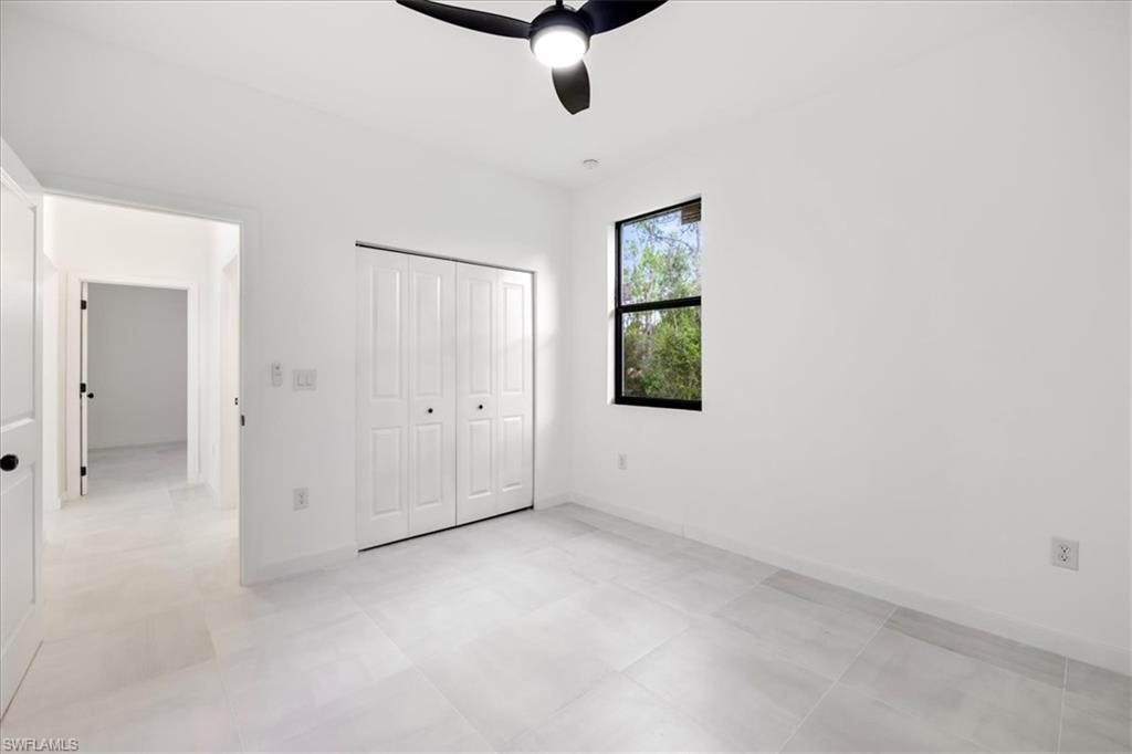 Unfurnished bedroom featuring ceiling fan and a closet