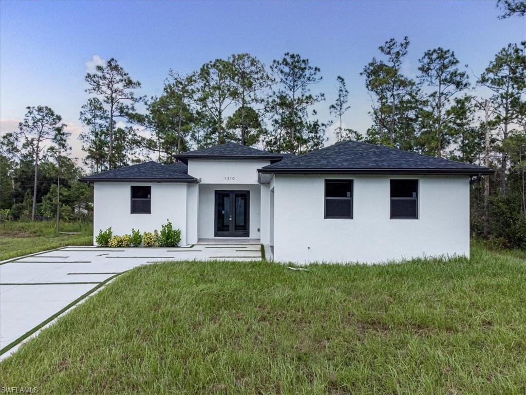 View of front of property with a front yard