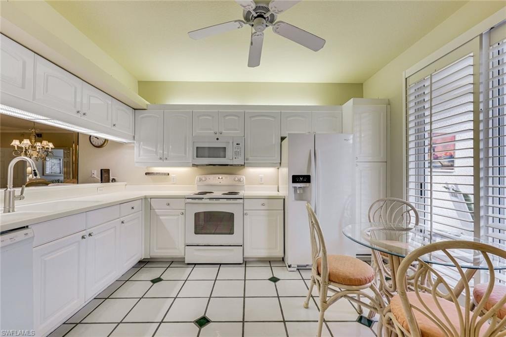 KITCHEN WITH A SLIDING DOOR LEADING TO THE FRONT PORCH AREA.FINISHED WITH PLANTATION SHUTTERS