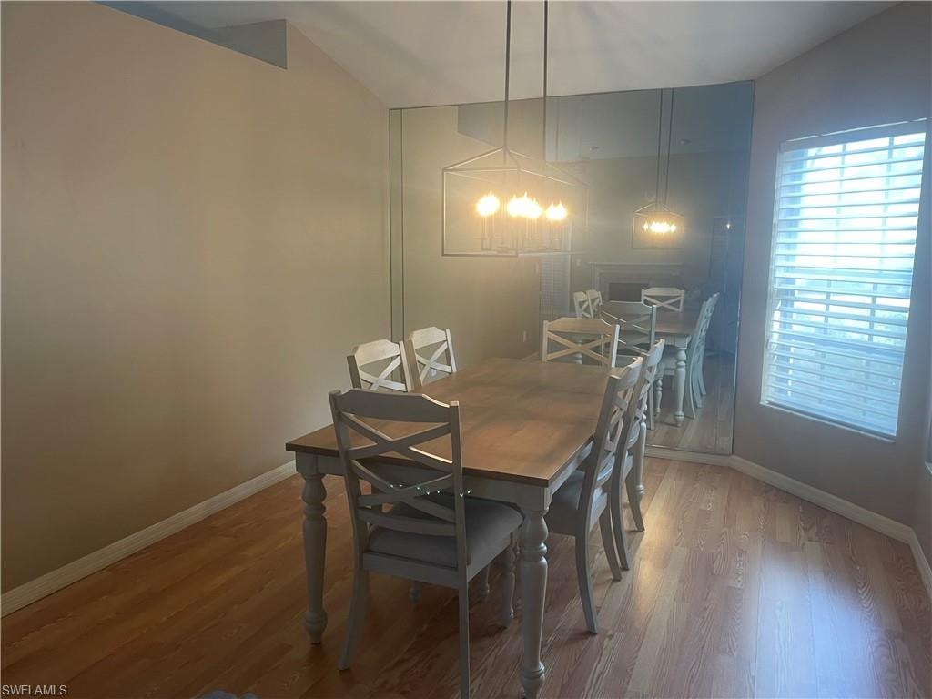 Dining area with warm-toned wood-finish flooring