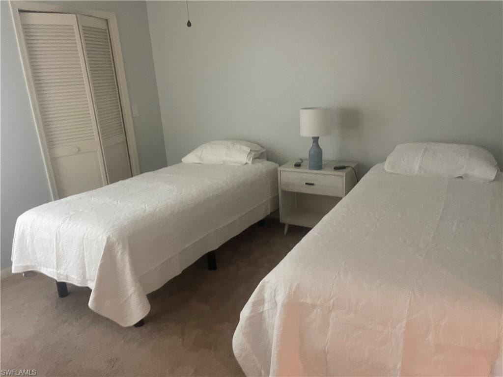 Bedroom featuring light-colored walls and carpeted flooring