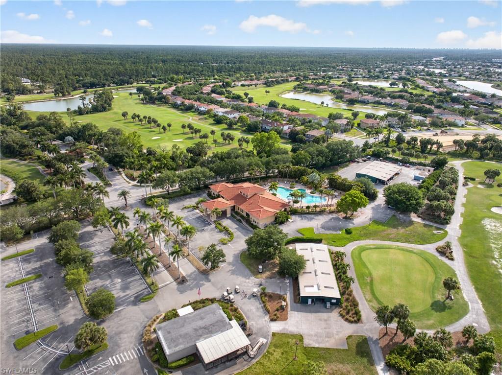 Aerial perspective showcasing a residential community with a central clubhouse featuring a swimming pool
