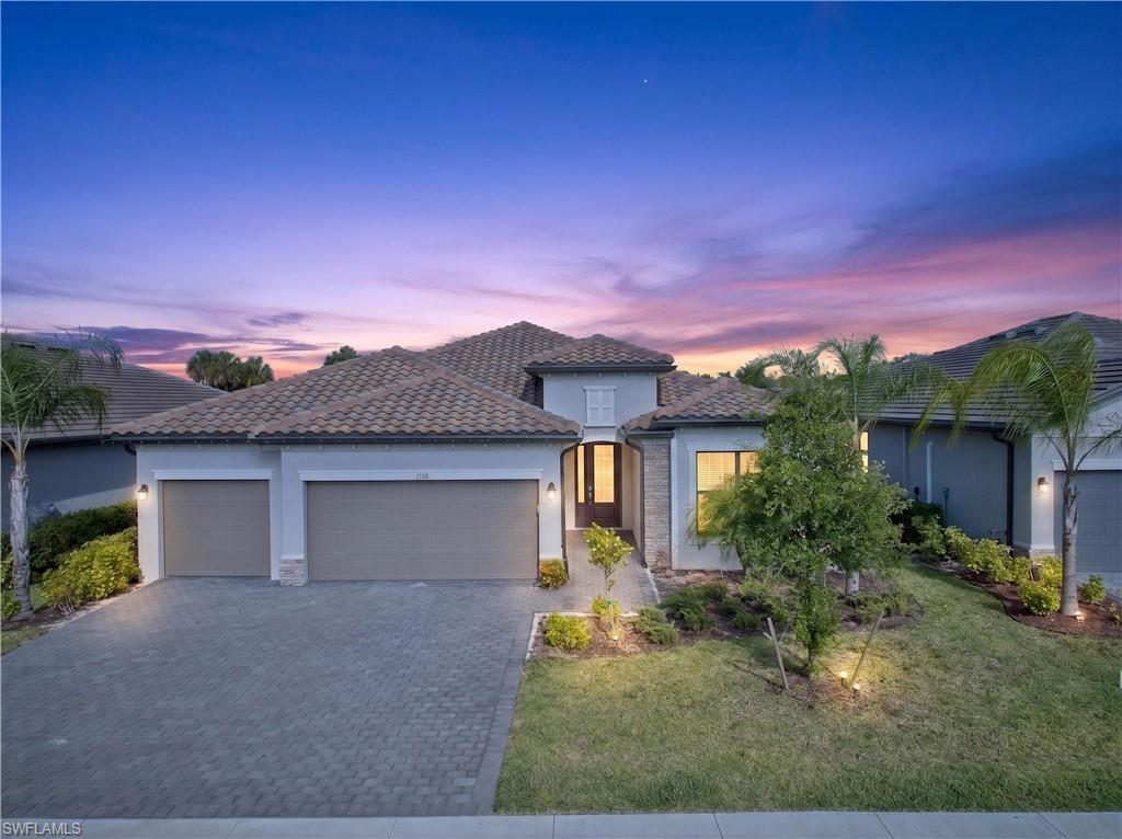 Contemporary facade featuring a tile roof and stone accents