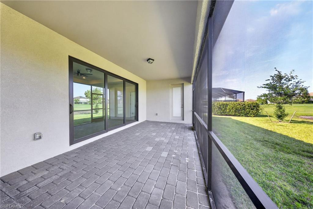 Expansive screened patio featuring dark paver flooring