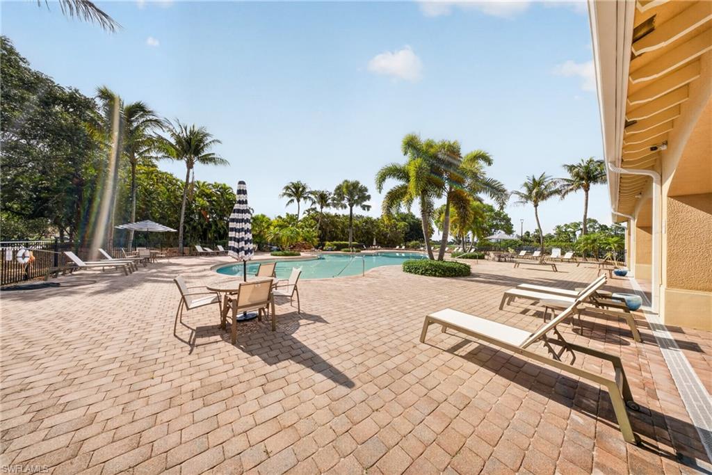 Expansive brick paver pool deck surrounding a large in-ground pool