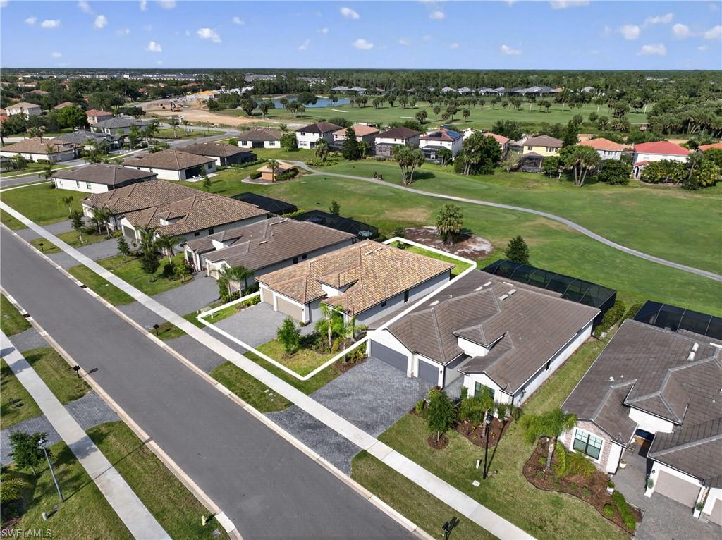 Contemporary residential property featuring a neutral-toned exterior, a tiled roof, and an attached two-car garage