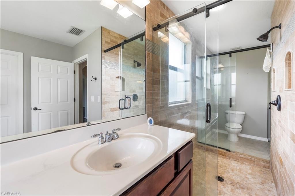 Full vanity with an integrated basin, chrome faucet, and dark wood-finish cabinetry