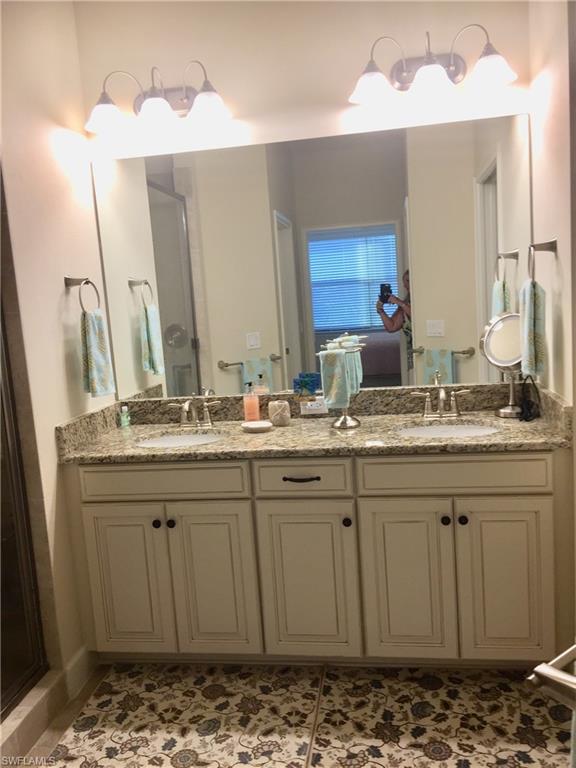 Full bathroom featuring double vanity and a sink