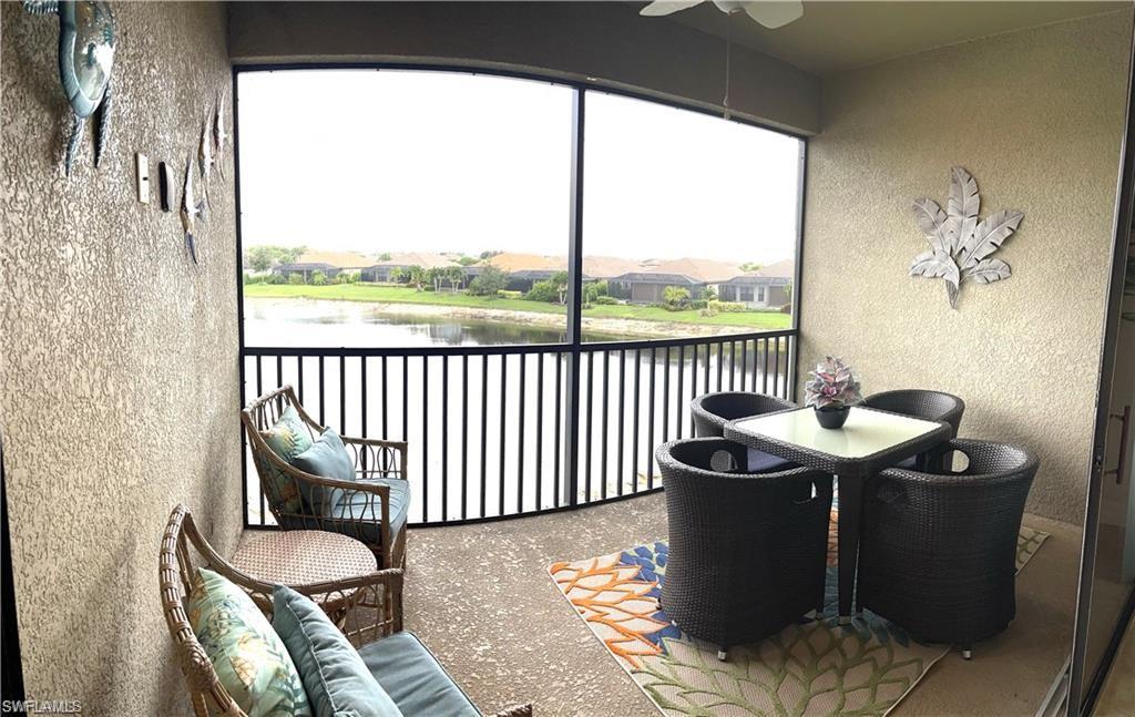 Sunroom featuring a water view and ceiling fan