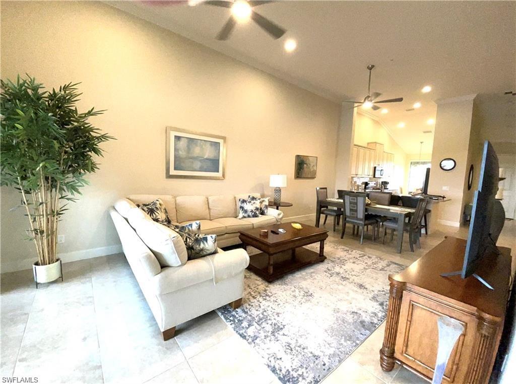 Living area featuring baseboards, a ceiling fan, recessed lighting, and lofted ceiling