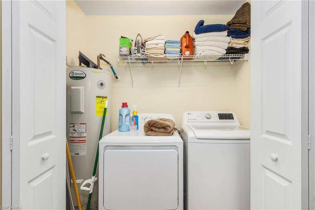 Laundry area with electric water heater and independent washer and dryer