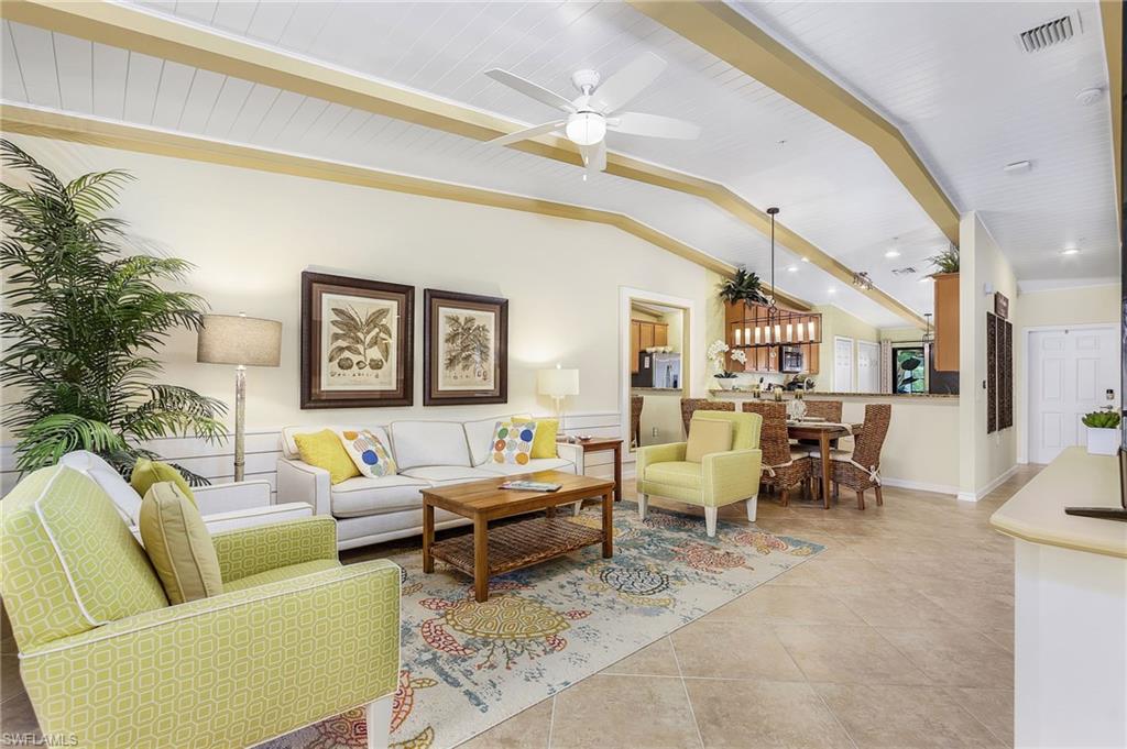 Living area with light tile patterned floors and ceiling fan