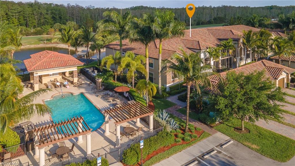 Bird's eye view of a pool area and a nearby body of water