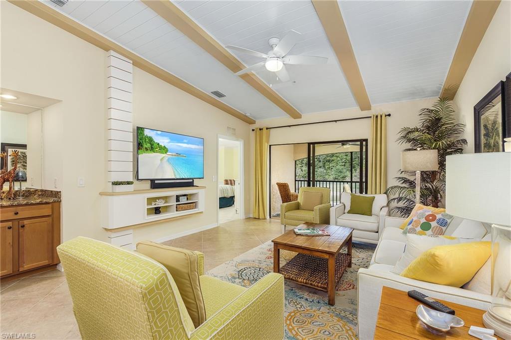 Living area featuring light tile patterned floors and a ceiling fan