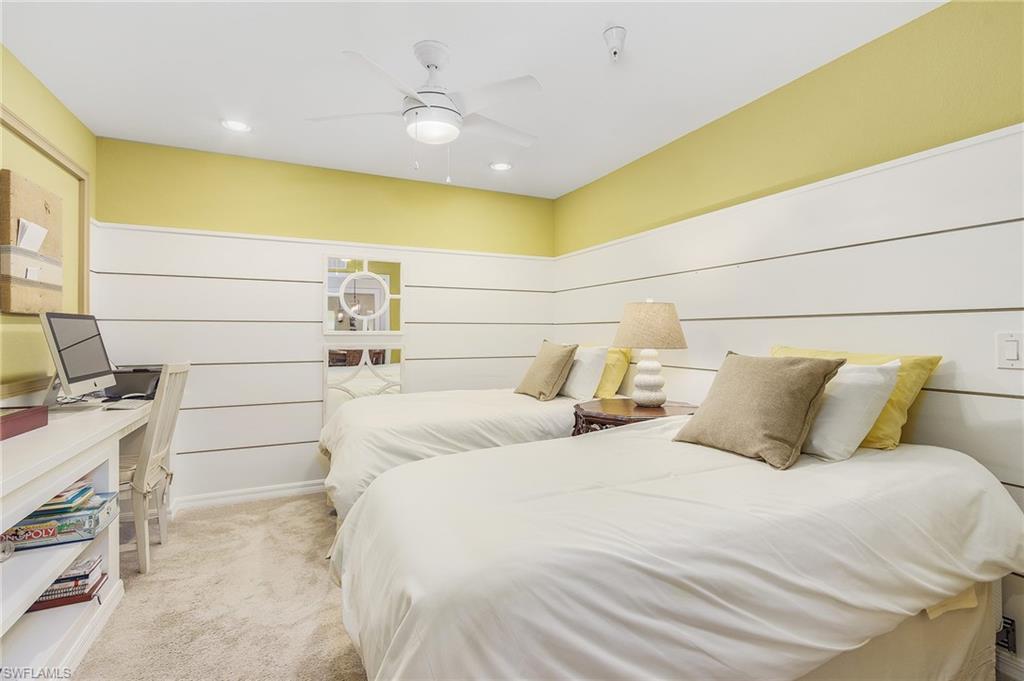 Bedroom with light colored carpet, ceiling fan, and recessed lighting