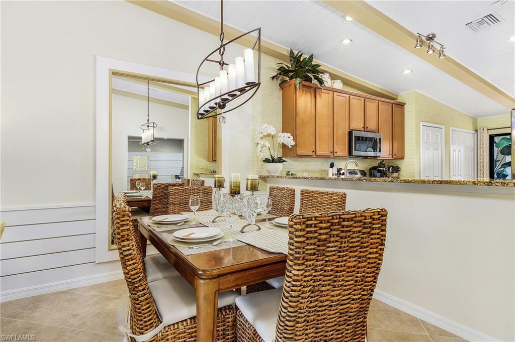 Dining space featuring light tile patterned floors and recessed lighting
