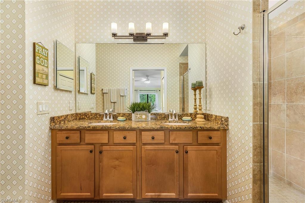 Bathroom with a shower stall and double vanity