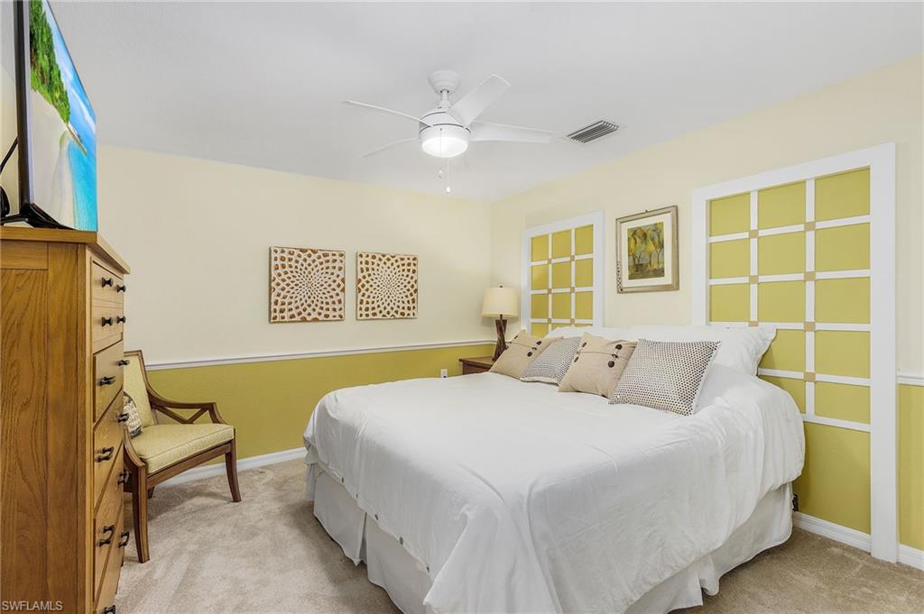 Bedroom featuring ceiling fan and light carpet