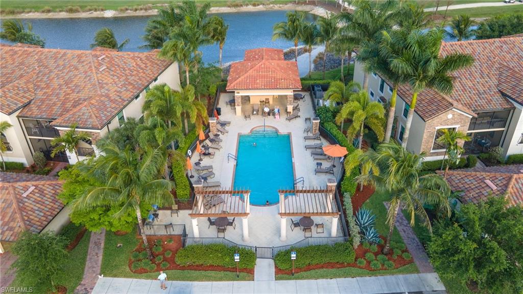 Bird's eye view of a nearby body of water and a pool