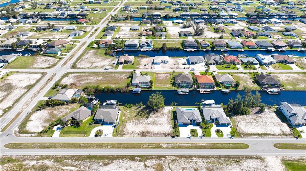 Aerial perspective showcasing a residential area featuring numerous canal-front properties