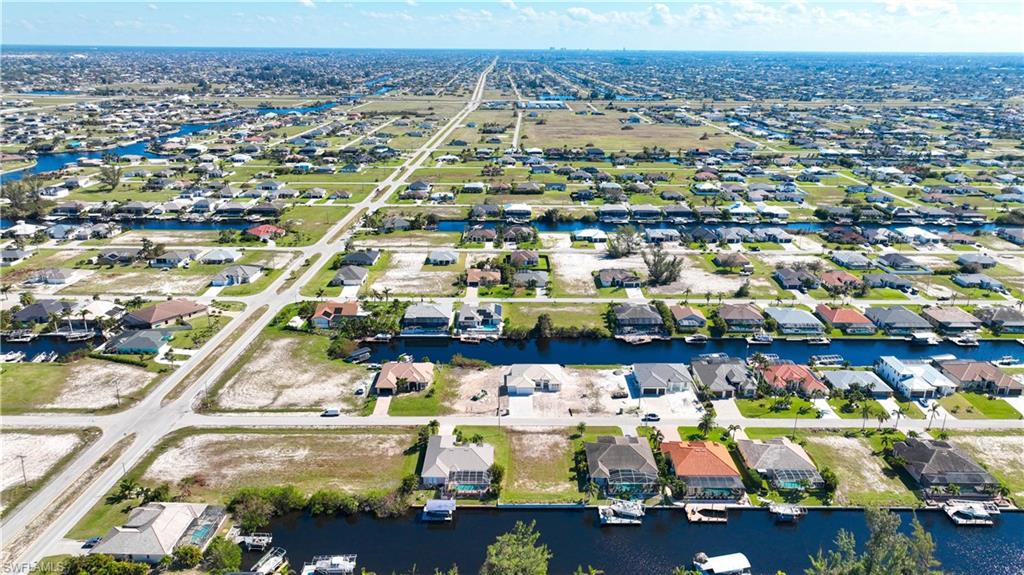Aerial perspective showcasing a residential area with extensive canal access and numerous waterfront properties