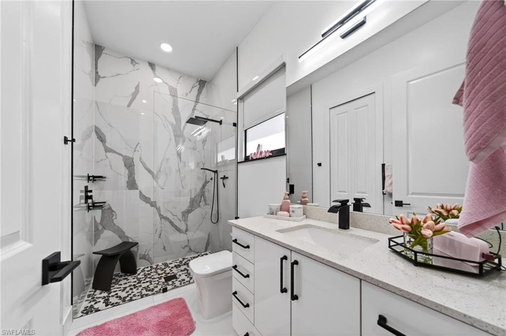 The 3rd room has a bathroom featuring a spacious glass-enclosed shower with large-format tile and a patterned pebble floor, and huge walking closet