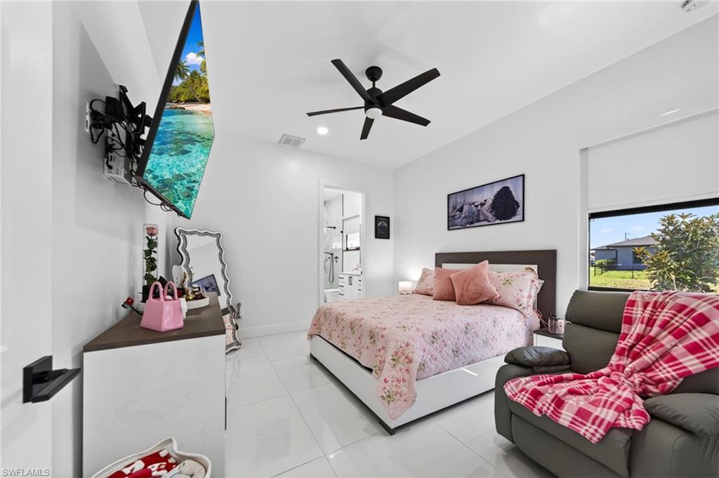 Spacious 3rd room featuring large-format tile flooring, a contemporary ceiling fan, and a wide window with roller blinds
