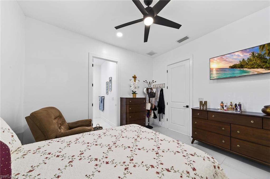 Spacious 2nd room featuring white walls, a contemporary ceiling fan, and wood-finish dressers, and full bathroom