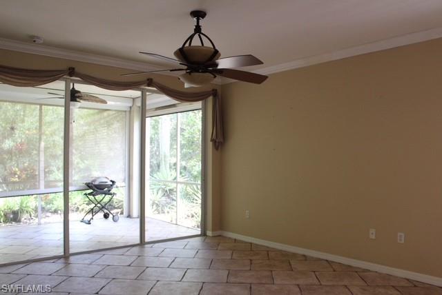 Spacious room featuring tile flooring, a screen-enclosed patio, and a ceiling fan with integrated lighting