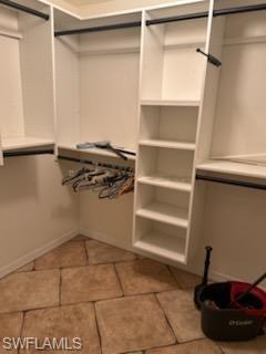 Custom closet system featuring white shelving and hanging rods