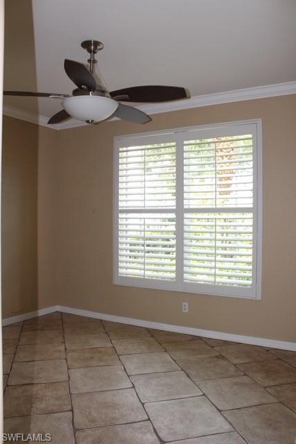 Neutral-toned walls complement the large window with plantation shutters