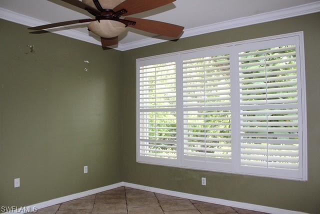 Expansive window with white plantation shutters