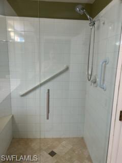 Walk-in shower with clear glass enclosure and a built-in bench