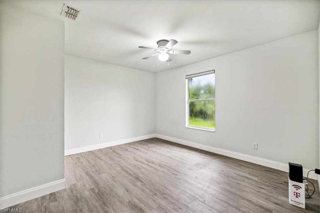 Unfurnished room featuring ceiling fan and hardwood / wood-style floors