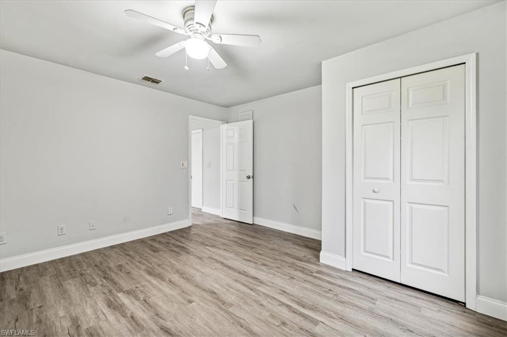 Unfurnished bedroom featuring light hardwood / wood-style floors, ceiling fan, and a closet