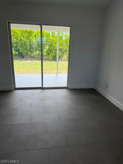 Sliding glass door opening to an outdoor patio with a grassy area